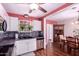 An eat-in kitchen offers stainless dishwasher and sink, mosaic backsplash, and hardwood floors at 9603 N 1St Ave, Phoenix, AZ 85021