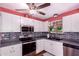 Efficient kitchen featuring stainless steel appliances, white cabinets, and a modern backsplash at 9603 N 1St Ave, Phoenix, AZ 85021