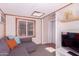 Comfortable room featuring neutral colors, carpet, a window, and a door leading to another space at 9603 N 1St Ave, Phoenix, AZ 85021