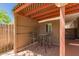 A cozy covered outdoor patio with brick flooring and two chairs at 9603 N 1St Ave, Phoenix, AZ 85021