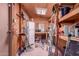Interior view of a shed with shelves, tools, paint cans, storage, and a small refrigerator at 9603 N 1St Ave, Phoenix, AZ 85021