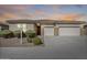Charming single-story home featuring a three-car garage and well-manicured landscaping at 9952 W Jessie Ln, Peoria, AZ 85383