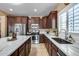 Modern kitchen features stainless steel appliances, dark wood cabinets, and white countertops at 9952 W Jessie Ln, Peoria, AZ 85383
