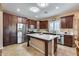 Spacious kitchen with stainless steel appliances, dark wood cabinets, and center island at 9952 W Jessie Ln, Peoria, AZ 85383