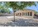 Private backyard features a covered patio, desert landscaping, and a concrete slab for entertaining at 1026 E Julie Ave, San Tan Valley, AZ 85140