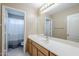 Well-lit bathroom featuring marble floors, spacious vanity with white countertop and a large mirror at 1026 E Julie Ave, San Tan Valley, AZ 85140