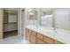 Bright bathroom featuring a double sink vanity, large mirror, and walk-in closet at 1026 E Julie Ave, San Tan Valley, AZ 85140
