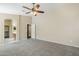 Relaxing bedroom featuring neutral carpet, ceiling fan, and ensuite bathroom at 1026 E Julie Ave, San Tan Valley, AZ 85140