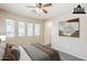 Staged bedroom featuring neutral tones, carpet, natural light from the windows and a ceiling fan at 1026 E Julie Ave, San Tan Valley, AZ 85140