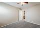Bedroom with neutral tones, carpet, and an open door leading to another room at 1026 E Julie Ave, San Tan Valley, AZ 85140