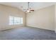 Neutral bedroom with carpet, high ceilings and a ceiling fan at 1026 E Julie Ave, San Tan Valley, AZ 85140