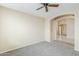 Neutral bedroom featuring neutral carpet, archway, and bright light at 1026 E Julie Ave, San Tan Valley, AZ 85140