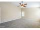 Comfortable bedroom with neutral carpet, ceiling fan, and bright natural light at 1026 E Julie Ave, San Tan Valley, AZ 85140