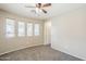 Comfortable bedroom showcasing natural light, a ceiling fan, and plush carpeting, perfect for relaxation at 1026 E Julie Ave, San Tan Valley, AZ 85140