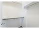Bright, walk-in closet with white walls, built-in shelves and a rail, maximizing storage space at 1026 E Julie Ave, San Tan Valley, AZ 85140