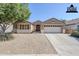 Home exterior showcasing a low-maintenance desert landscape, two-car garage, and stylish curb appeal at 1026 E Julie Ave, San Tan Valley, AZ 85140
