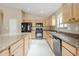 Well-appointed kitchen featuring granite countertops, black appliances, and a functional island at 1026 E Julie Ave, San Tan Valley, AZ 85140