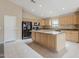 Well-lit kitchen with granite countertops, black appliances, and a functional center island at 1026 E Julie Ave, San Tan Valley, AZ 85140