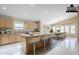 Eat-in kitchen with a large island, modern lighting and dining area beyond at 1026 E Julie Ave, San Tan Valley, AZ 85140