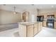 Updated kitchen with black appliances and ample counter space open to the living area at 1026 E Julie Ave, San Tan Valley, AZ 85140