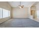 Bright living room with carpet, neutral walls, and a ceiling fan at 1026 E Julie Ave, San Tan Valley, AZ 85140