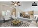 Open-concept design with a kitchen and a living room provides ample space for relaxing and entertaining at 1026 E Julie Ave, San Tan Valley, AZ 85140