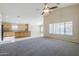 Open-concept living room and kitchen area with carpet and tile floors at 1026 E Julie Ave, San Tan Valley, AZ 85140