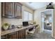 This office space includes built-in desk and cabinetry with a view to the bedroom at 1026 E Julie Ave, San Tan Valley, AZ 85140