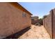 Enclosed backyard with cinder block walls, dirt ground and outdoor seating area at 1130 E Ferrara St, San Tan Valley, AZ 85140