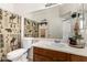 Bathroom with a wood vanity and a shower-tub combo with a patterned curtain at 1130 E Ferrara St, San Tan Valley, AZ 85140