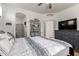 Bedroom with a large bed, an entertainment center, and access to an en-suite bathroom and closet at 1130 E Ferrara St, San Tan Valley, AZ 85140