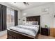 Cozy bedroom with a large bed, windows for natural light, and neutral-toned walls and flooring at 1130 E Ferrara St, San Tan Valley, AZ 85140