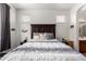 Bright bedroom featuring a large headboard, bedside tables, and white and navy patterned bedding at 1130 E Ferrara St, San Tan Valley, AZ 85140