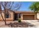 Charming single story home with desert landscaping, an attached garage and a tile roof at 1130 E Ferrara St, San Tan Valley, AZ 85140