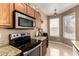 Well-lit kitchen with granite countertops, stainless steel appliances and wooden cabinetry at 1130 E Ferrara St, San Tan Valley, AZ 85140