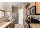 Well-lit kitchen with granite countertops, stainless steel appliances and wooden cabinetry at 1130 E Ferrara St, San Tan Valley, AZ 85140