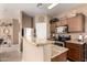 Well-lit kitchen with granite countertops, stainless steel appliances and wooden cabinetry at 1130 E Ferrara St, San Tan Valley, AZ 85140