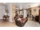Open-concept living room view featuring tile floors, a leather couch, and natural light at 1130 E Ferrara St, San Tan Valley, AZ 85140