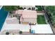 Aerial view showcasing roof, driveway and backyard with shed, firepit and green grass at 11419 E Ellis St, Mesa, AZ 85207