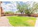 Lush backyard featuring green grass, rock landscaping, and a charming seating area at 11419 E Ellis St, Mesa, AZ 85207