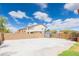 Expansive concrete backyard with storage shed, metal gate, and partial grass area at 11419 E Ellis St, Mesa, AZ 85207