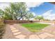 Large backyard with manicured lawn, stone landscaping and tall trees under a sunny sky at 11419 E Ellis St, Mesa, AZ 85207