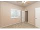 Neutral bedroom with carpet, ceiling fan, closet door, and shuttered window at 11419 E Ellis St, Mesa, AZ 85207