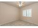 Bedroom with neutral walls, carpet, and shuttered window at 11419 E Ellis St, Mesa, AZ 85207