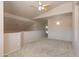Spacious bonus room features neutral paint, carpet, and ceiling fan with bright lights at 11419 E Ellis St, Mesa, AZ 85207