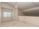 Large bonus room features neutral paint and carpet, bright light from the window at 11419 E Ellis St, Mesa, AZ 85207