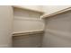 This walk in closet features built in shelves and rods for organization and storage at 11419 E Ellis St, Mesa, AZ 85207
