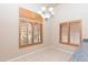 Bright dining area with wood shuttered windows, chandelier, and tile flooring at 11419 E Ellis St, Mesa, AZ 85207