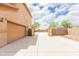 Long driveway leading to a two-car garage and gate to the backyard at 11419 E Ellis St, Mesa, AZ 85207