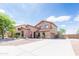 Lovely two-story home featuring desert landscaping, and a long driveway leading to the garage at 11419 E Ellis St, Mesa, AZ 85207